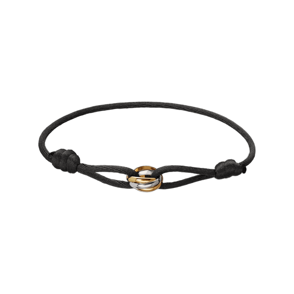 Cartier Trinity bracelet with a black cord and three interlocking white, yellow, and rose gold rings